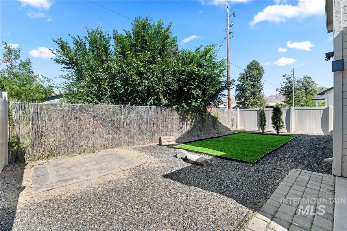 Fenced backyard with a patio