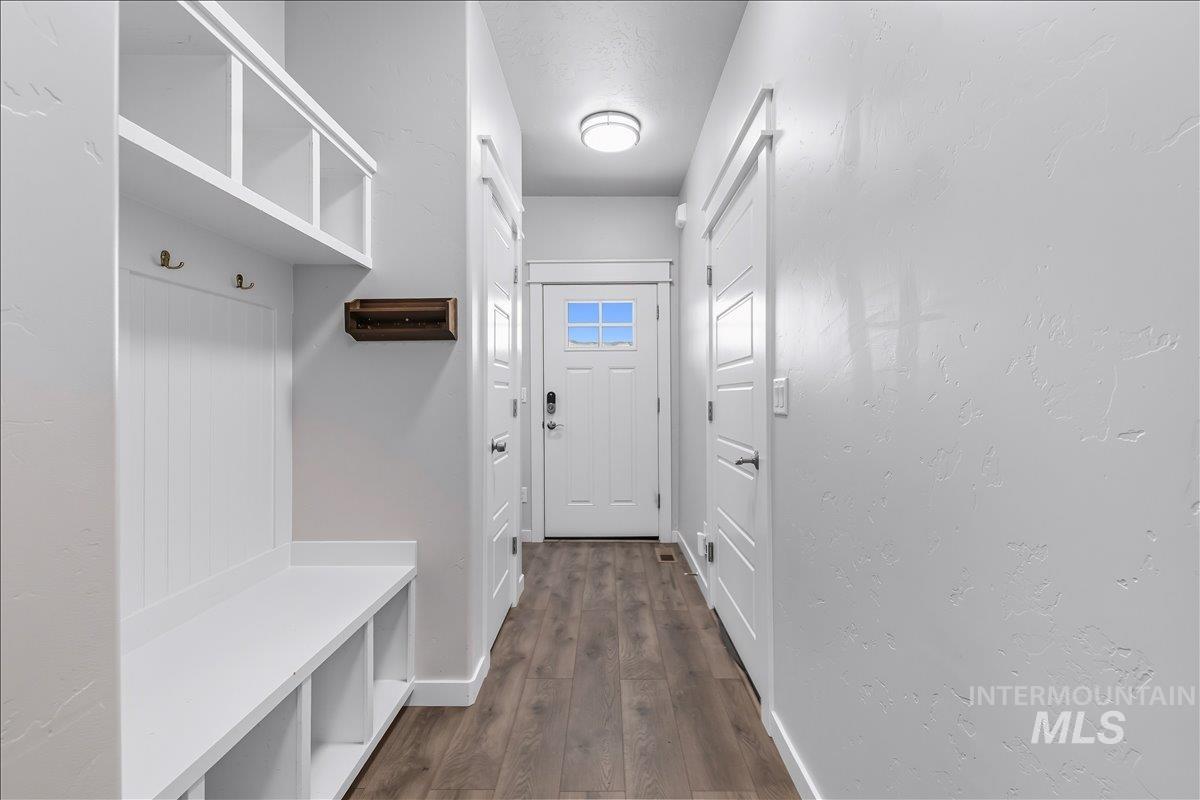 Mudroom featuring baseboards and dark wood-style flooring