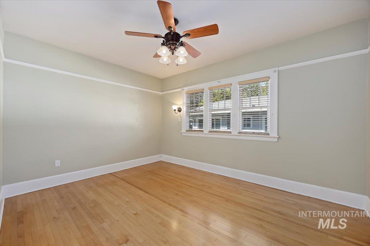 Spare room featuring light wood-style flooring and a ceiling fan