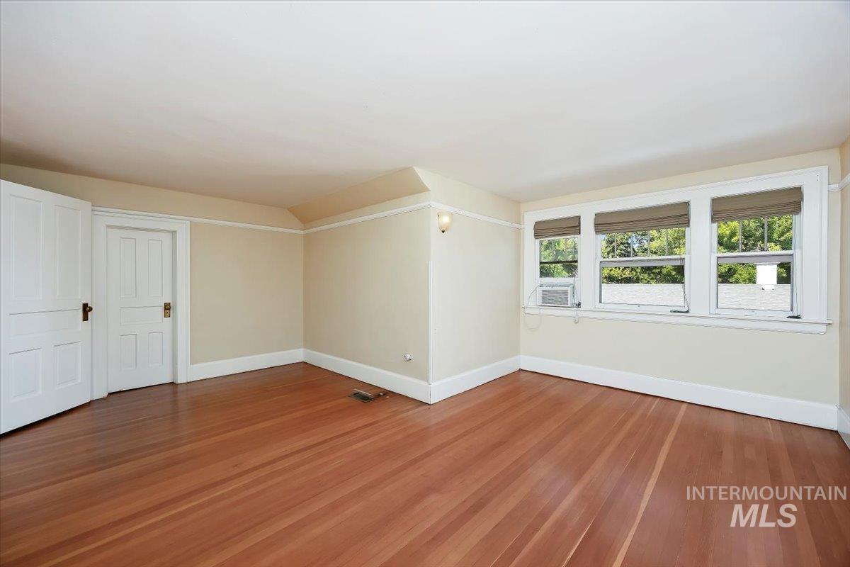 Empty room with light wood-style flooring and baseboards
