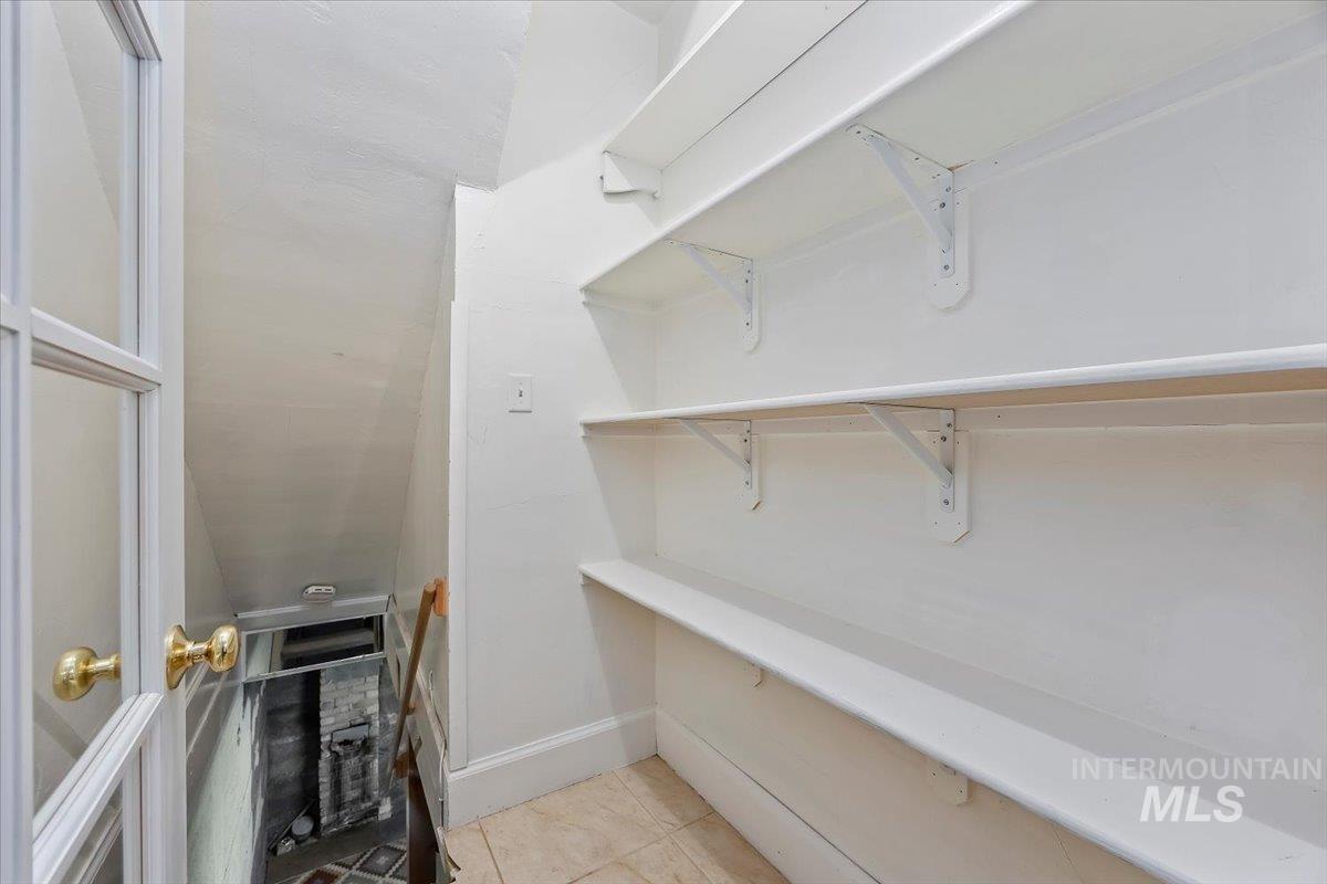 Walk in closet with light tile patterned floors