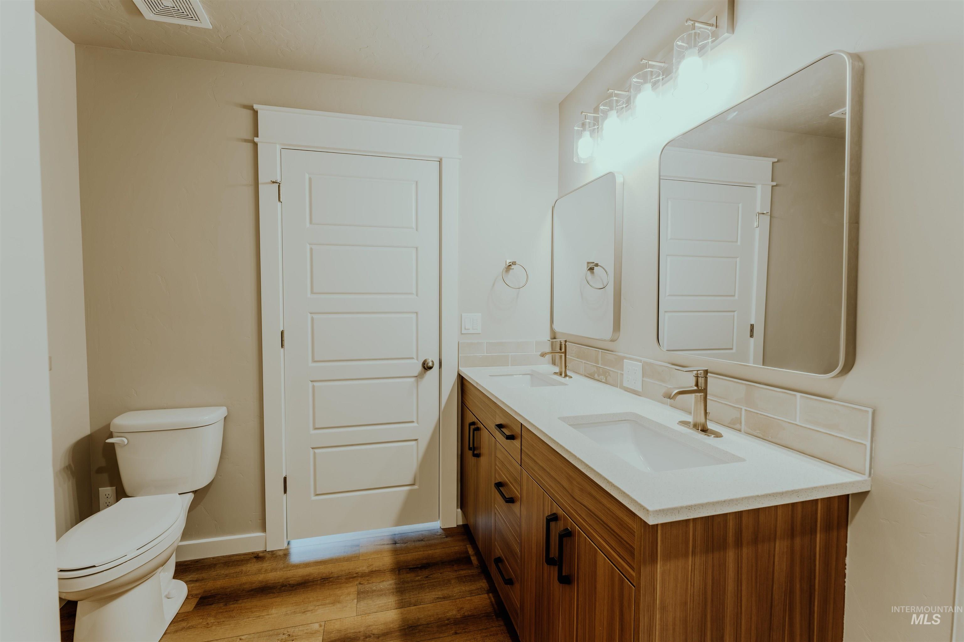 Bathroom featuring light wood-style floors and double vanity