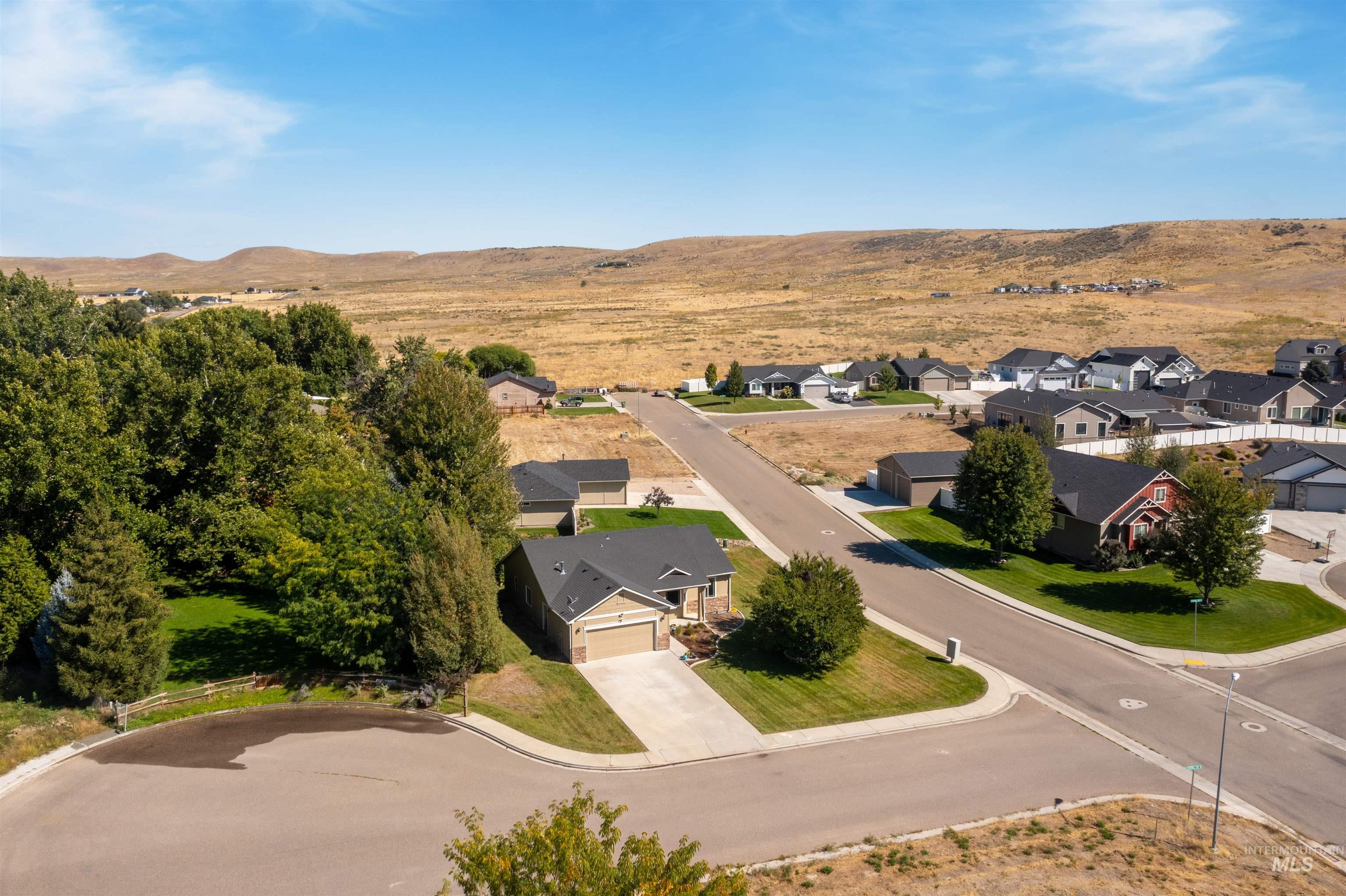 Aerial perspective of suburban area featuring a mountainous background