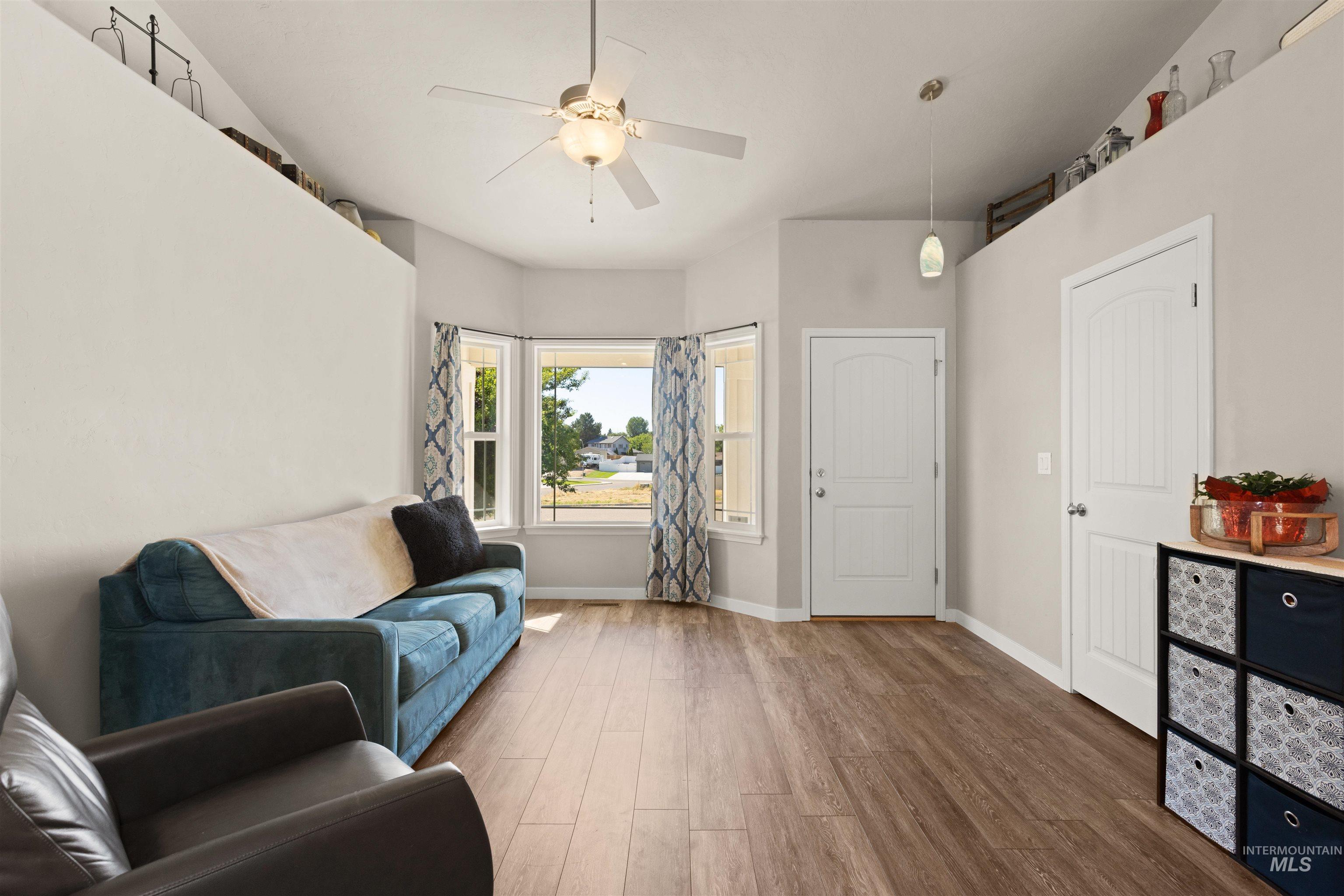 Living area featuring wood finished floors and ceiling fan