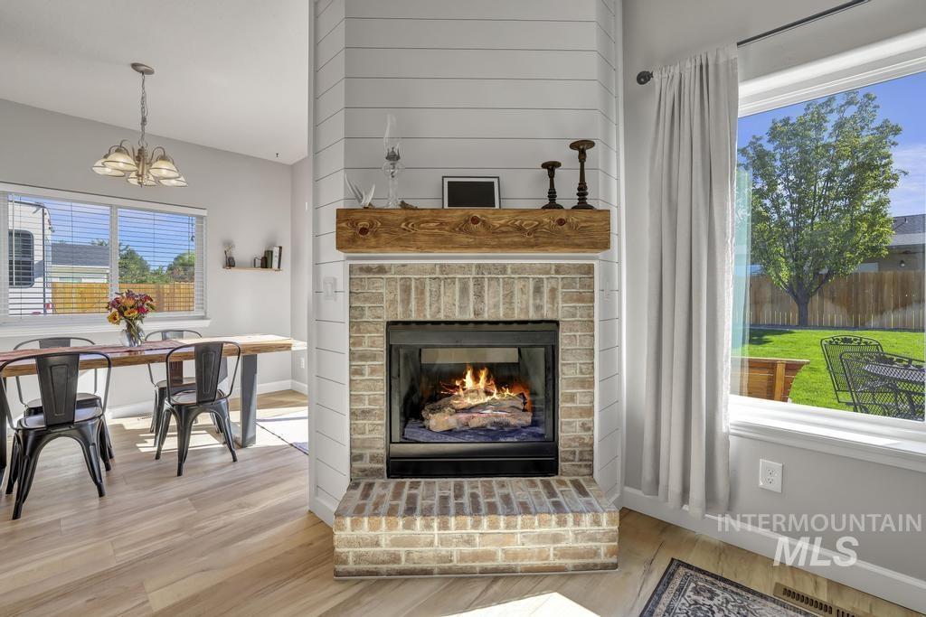Living area featuring light wood-style floors and a fireplace