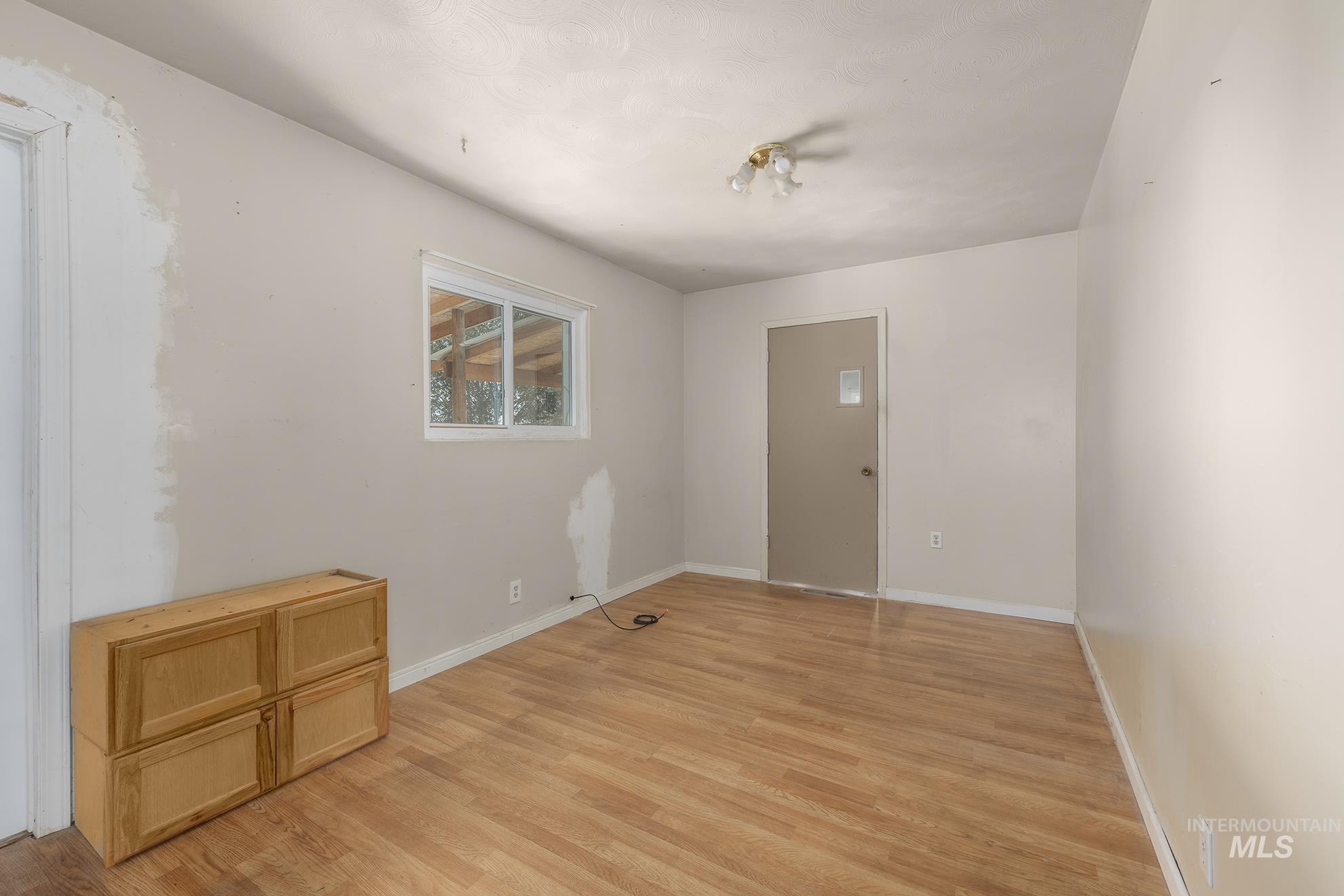 Empty room featuring light wood-style flooring and baseboards