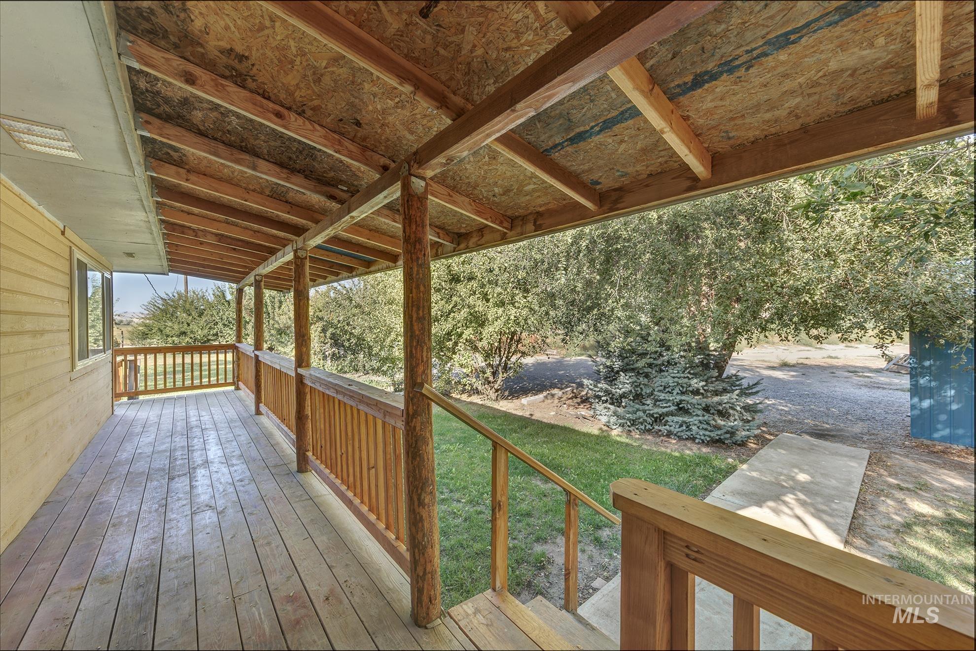 Wooden terrace featuring a yard