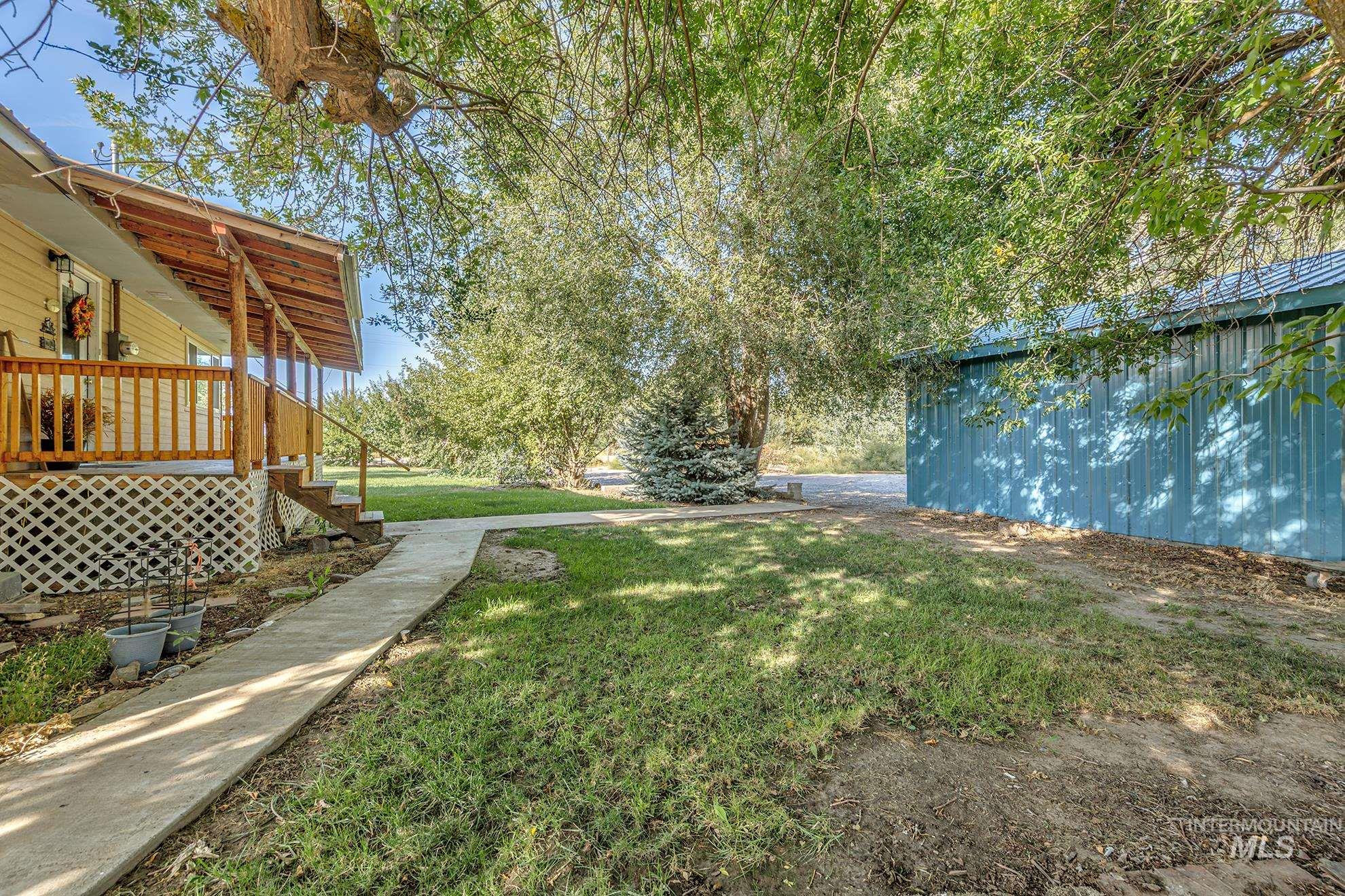View of green lawn featuring an outbuilding