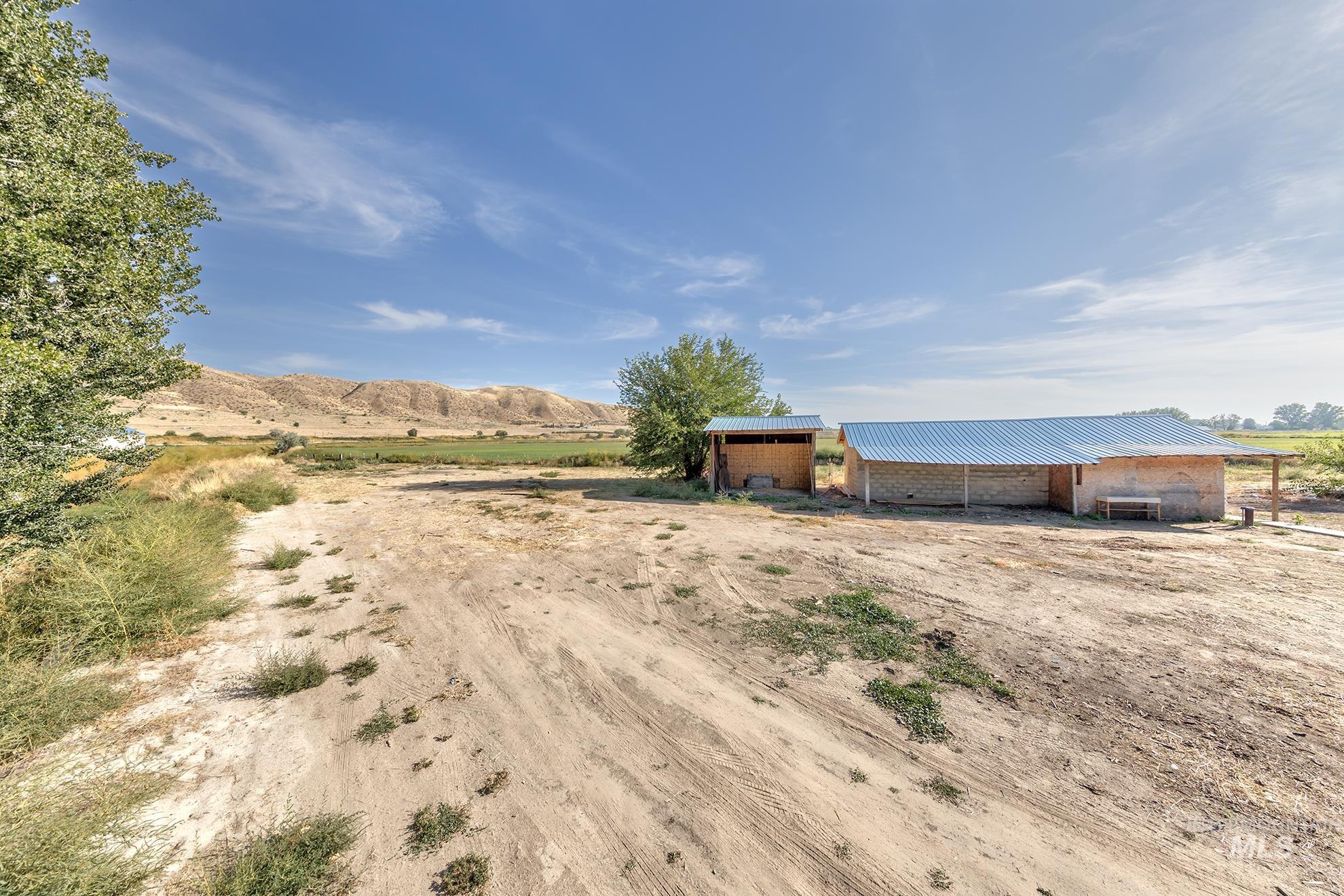 View of yard with a rural view, an outbuilding, and a mountain view