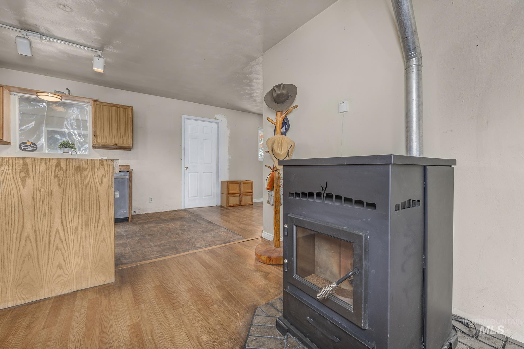 Detailed view of wood finished floors and a wood stove
