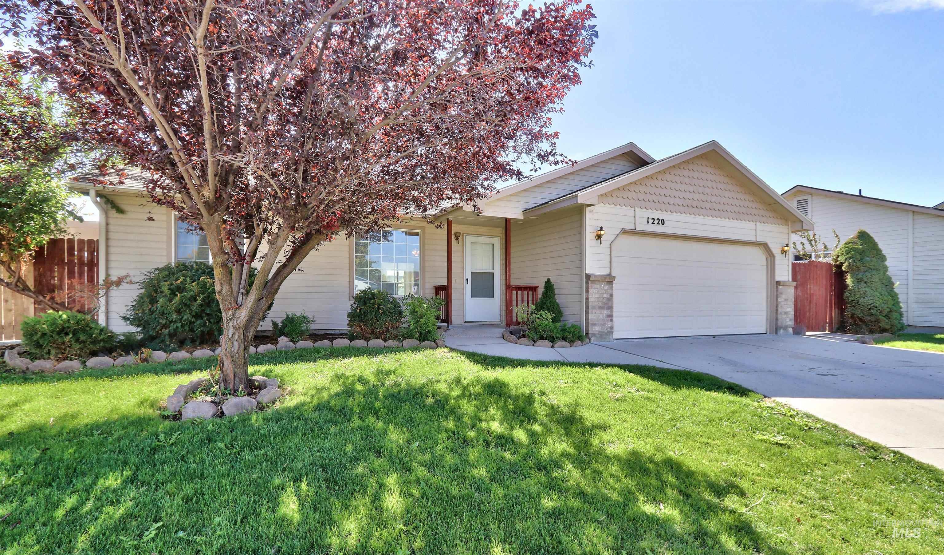 View of front of home featuring driveway and a garage