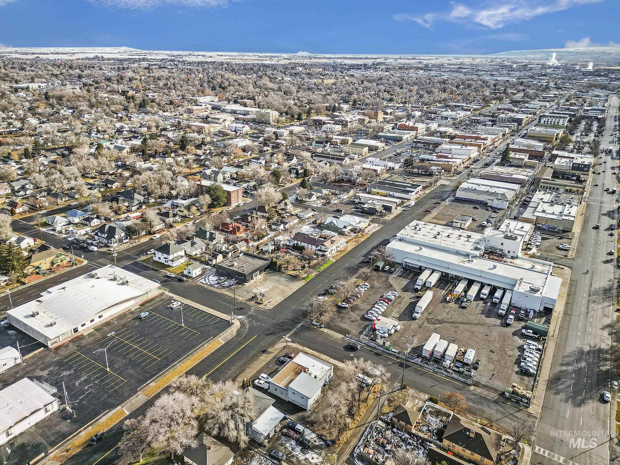 Aerial view of property and surrounding area with industrial structures