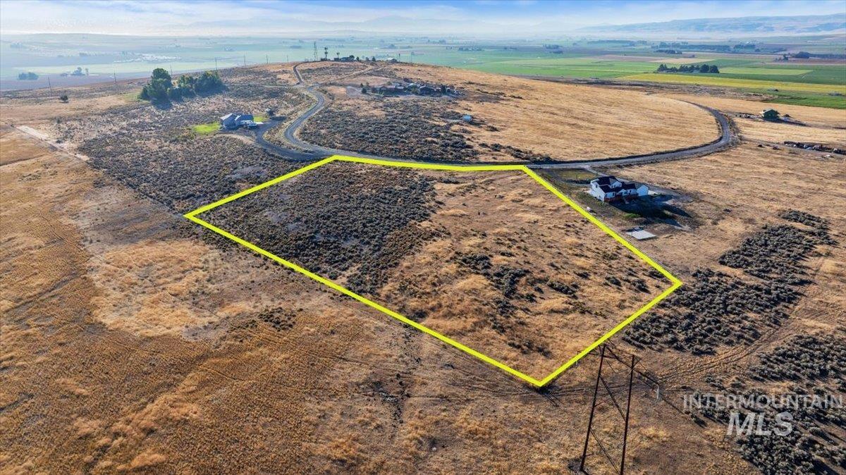 Aerial view of sparsely populated area with property parcel outlined