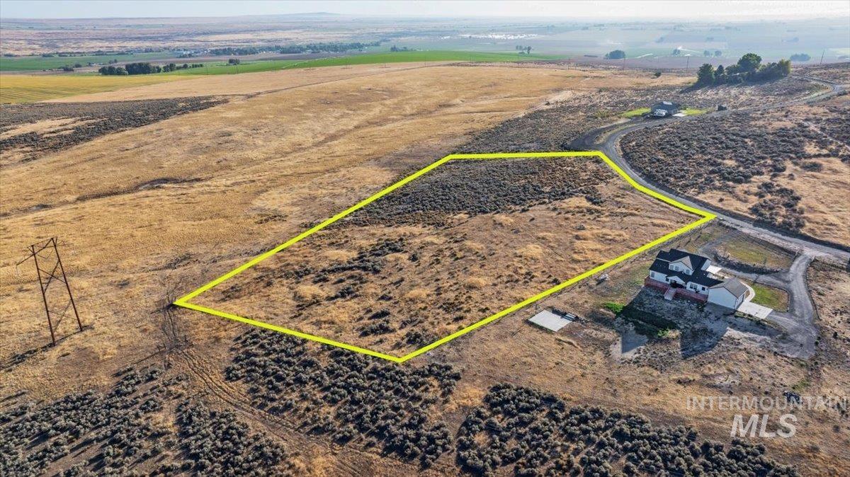 Aerial view of sparsely populated area featuring property boundaries highlighted