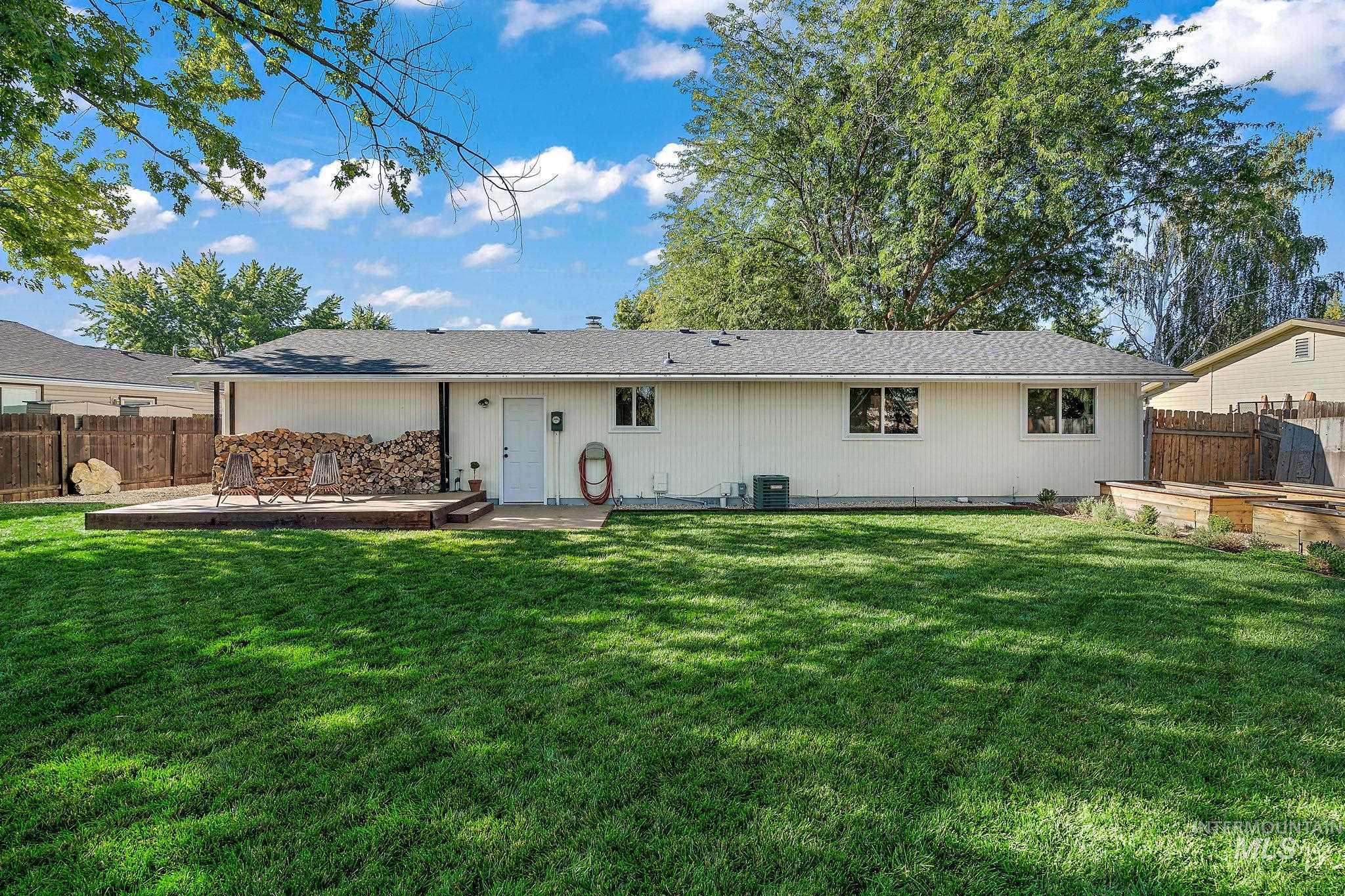 Rear view of property with a patio and roof with shingles