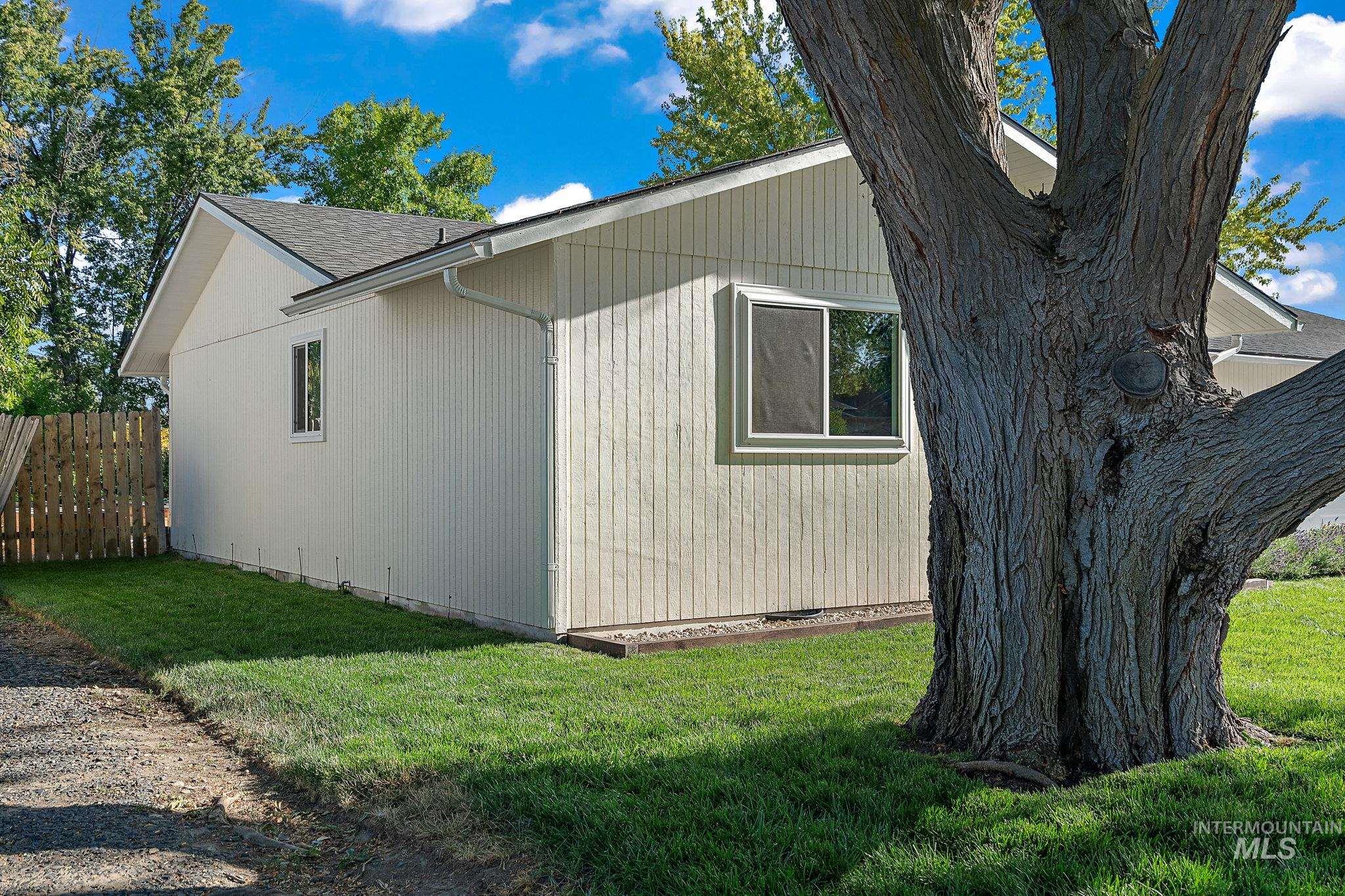 View of side of home featuring roof with shingles