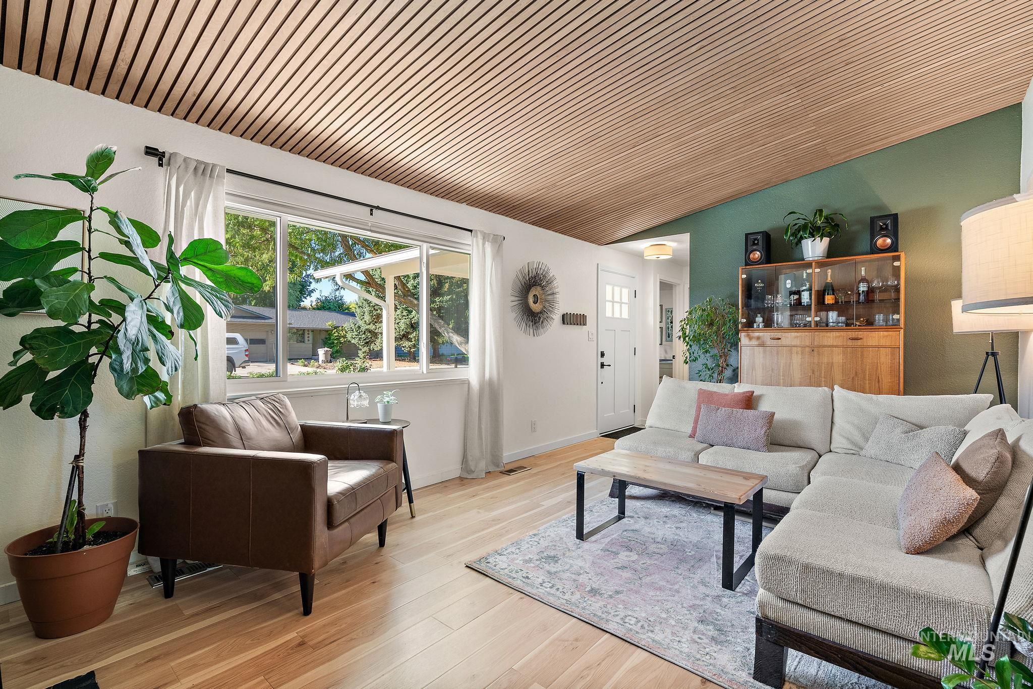 Living area with wood finished floors and lofted ceiling