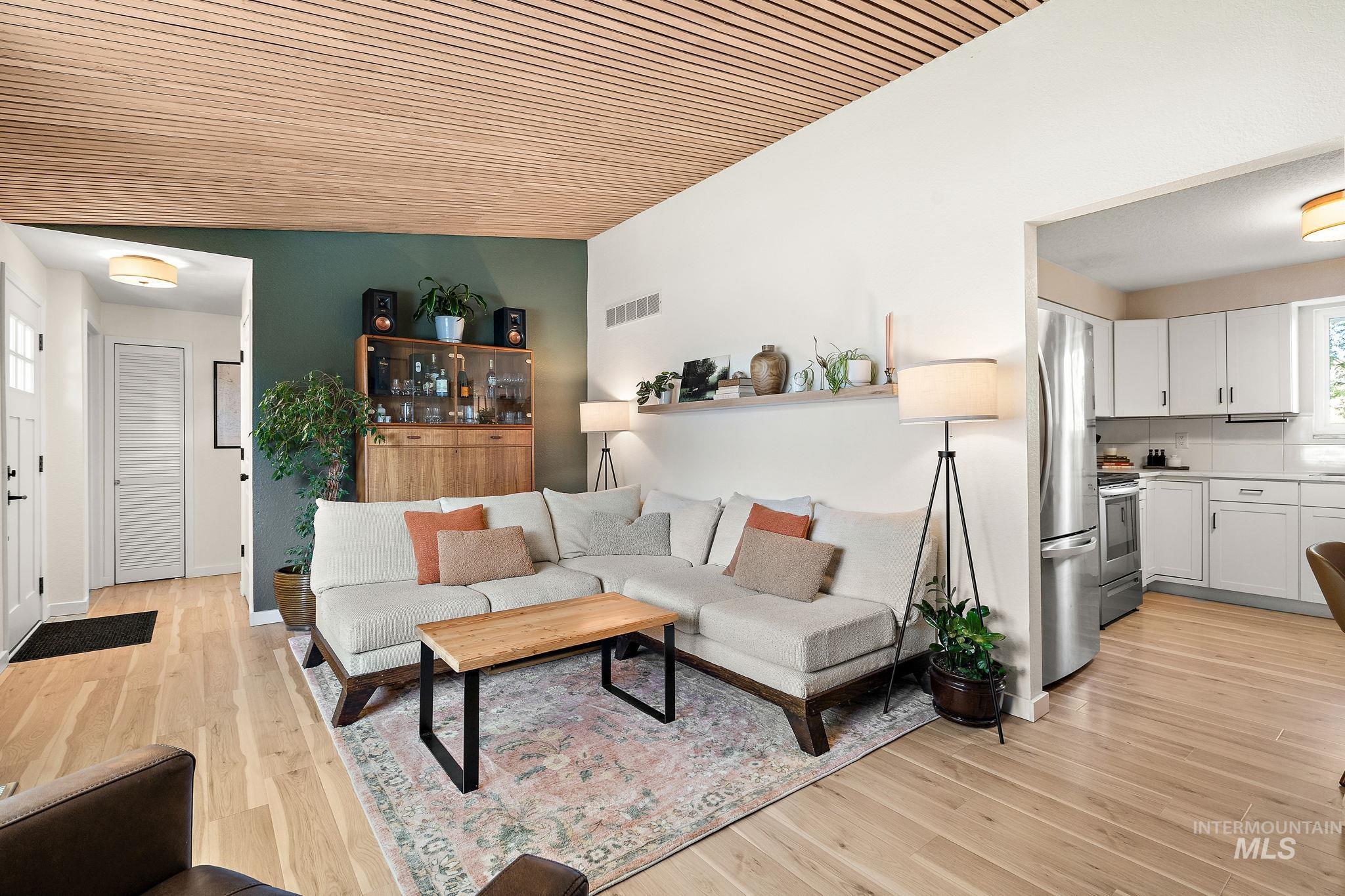Living room featuring light wood-style floors and plenty of natural light