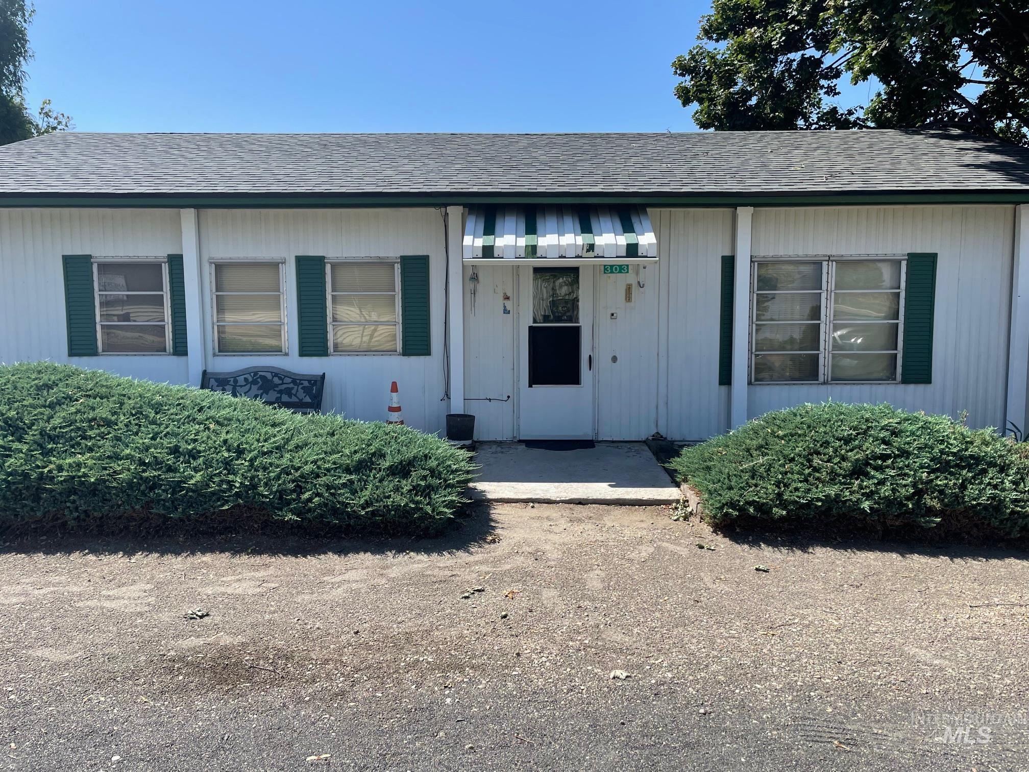 Entrance to property featuring roof with shingles