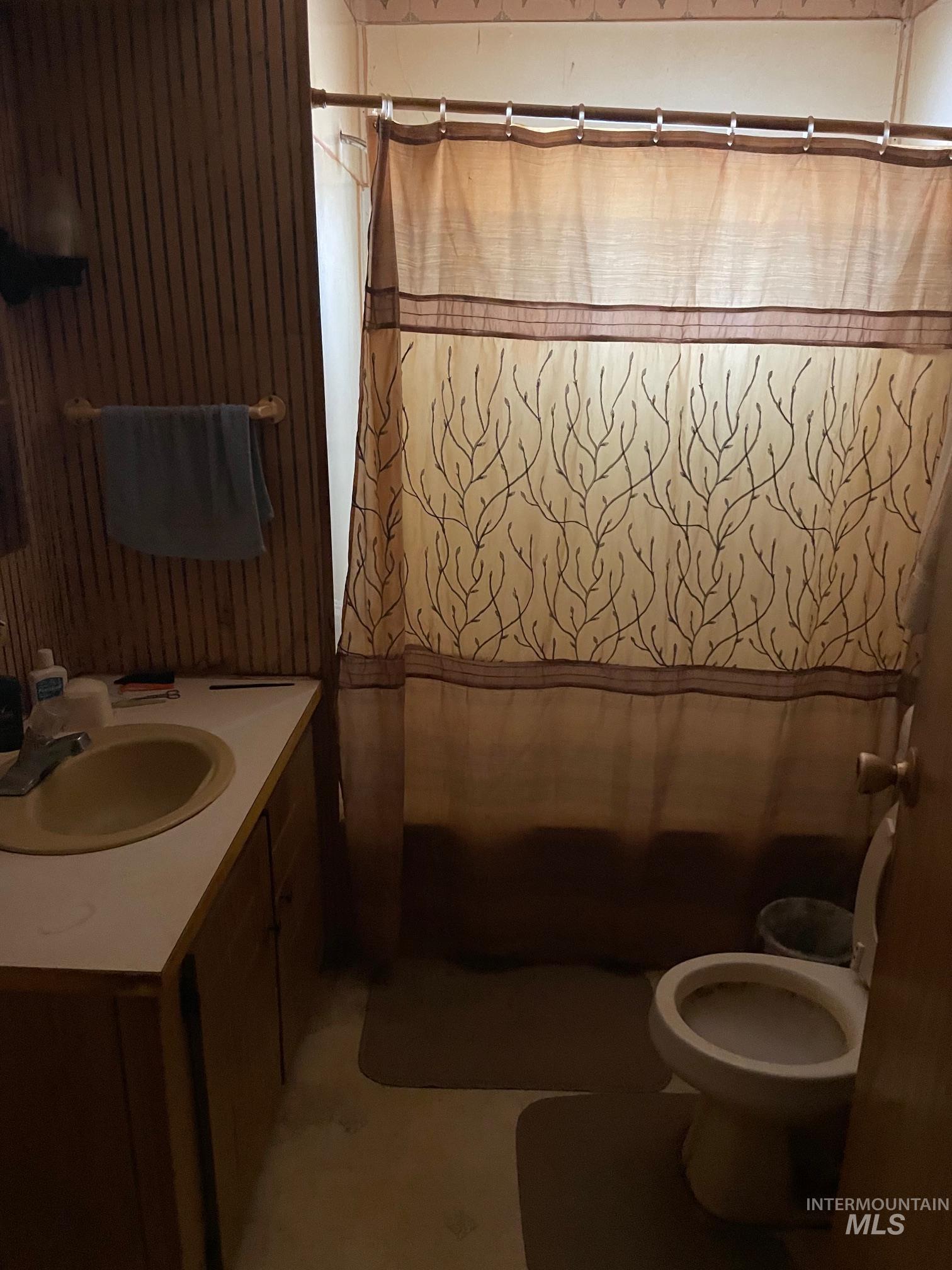 Full bath featuring vanity and shower / bath combo