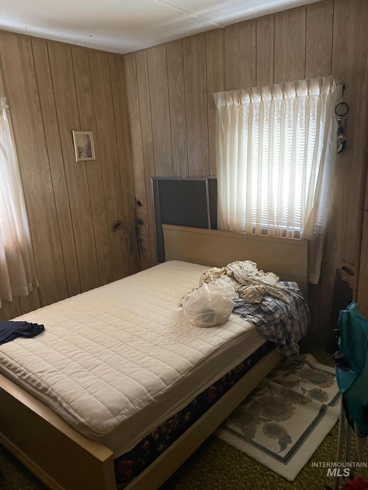 Bedroom with wooden walls