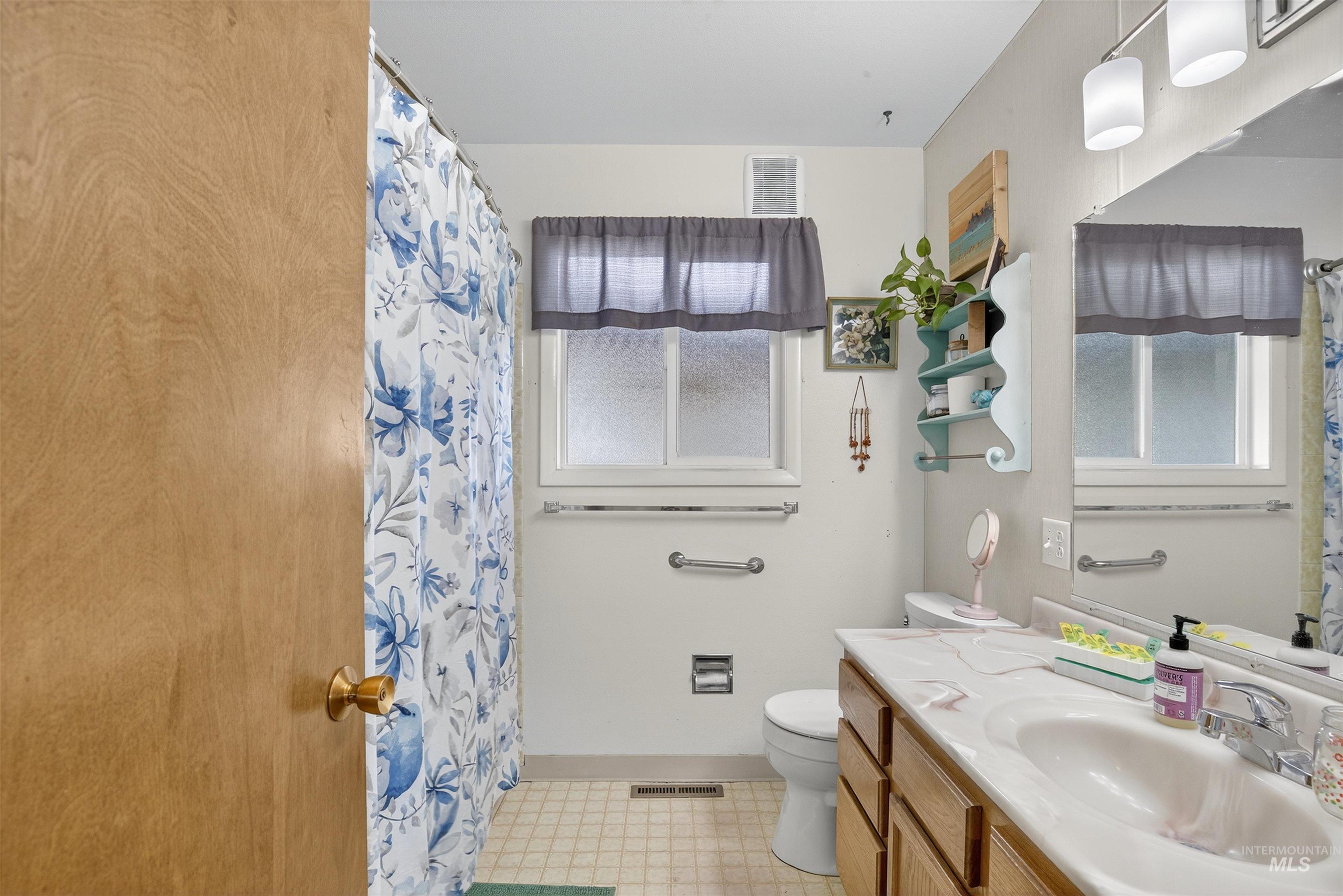 Bathroom with vanity and a shower with shower curtain
