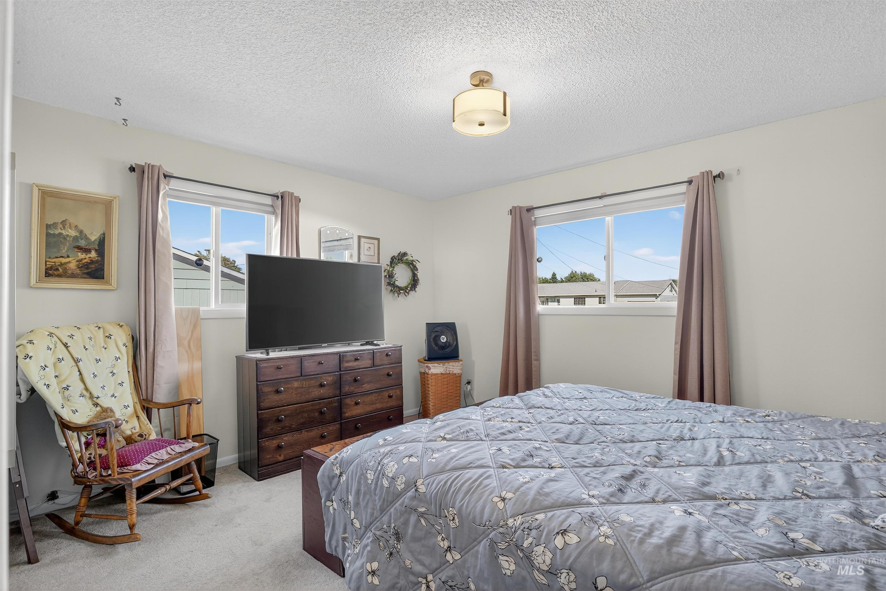 Bedroom featuring carpet and a textured ceiling
