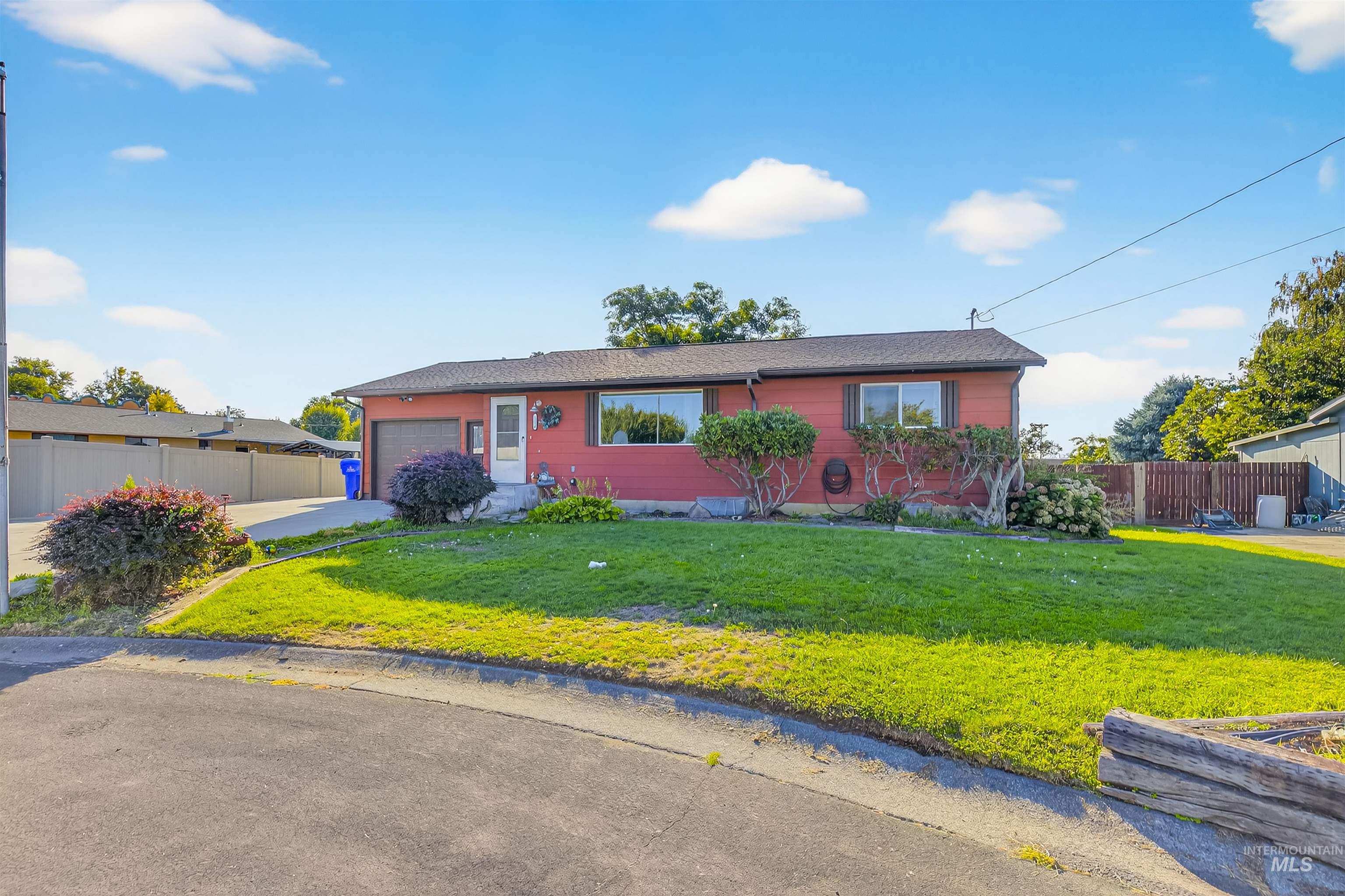 Ranch-style home featuring concrete driveway and a garage