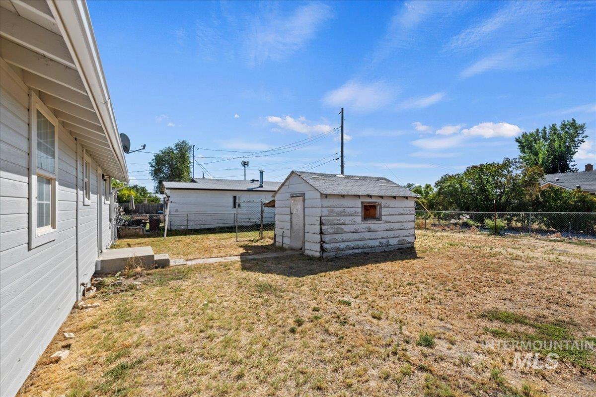 Fenced backyard with a storage shed