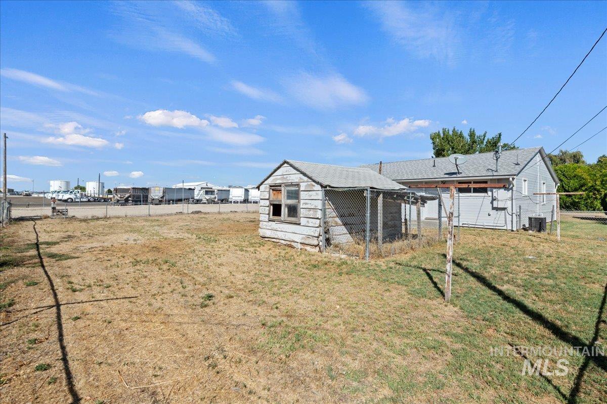 Back of house with an outbuilding and exterior structure