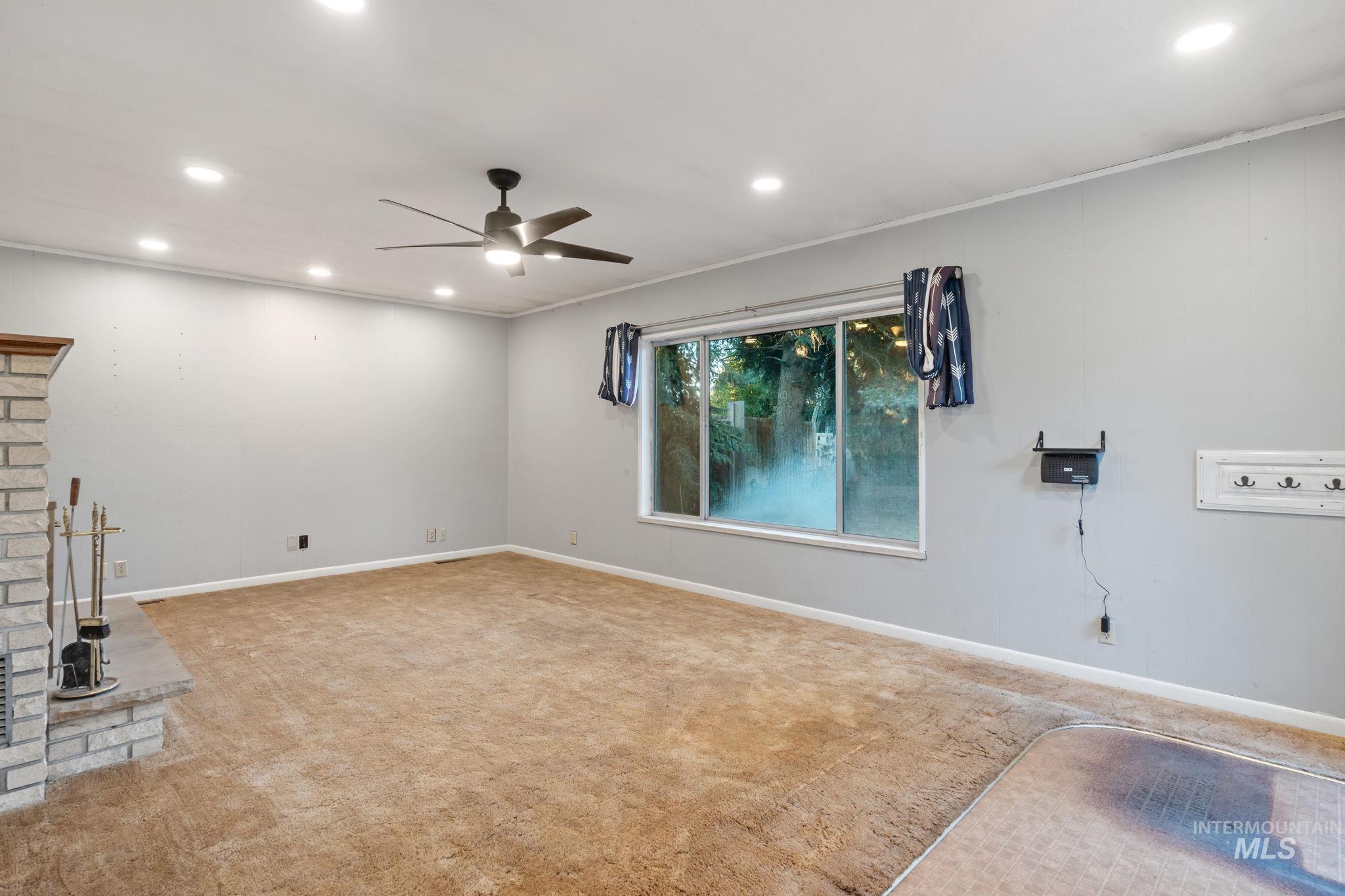 Unfurnished living room with recessed lighting, carpet flooring, and ceiling fan