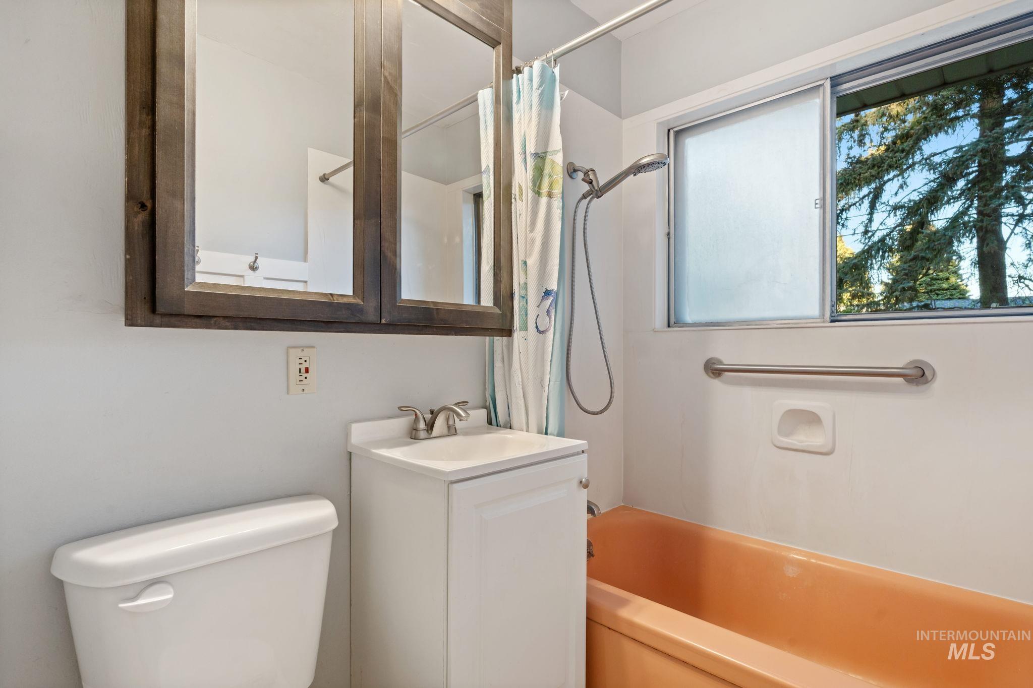 Bathroom featuring vanity and shower / bath combo