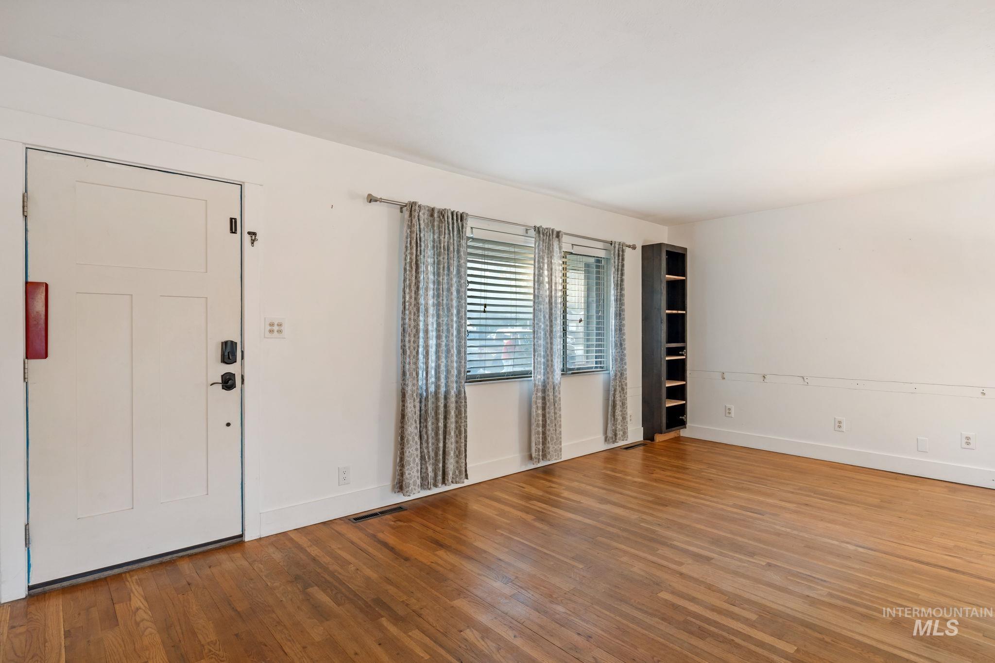 Entrance foyer with wood-type flooring
