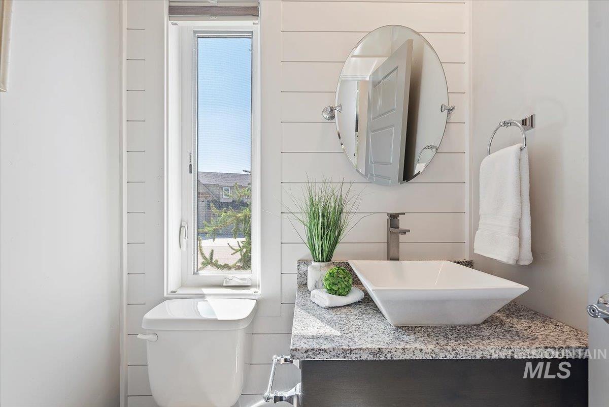 Half bathroom with vanity and toilet