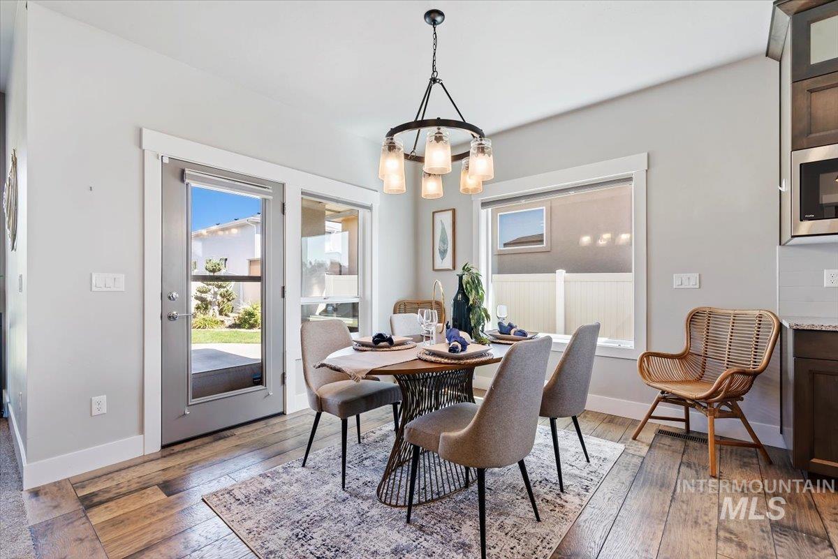 Dining room featuring wood-type flooring and a chandelier