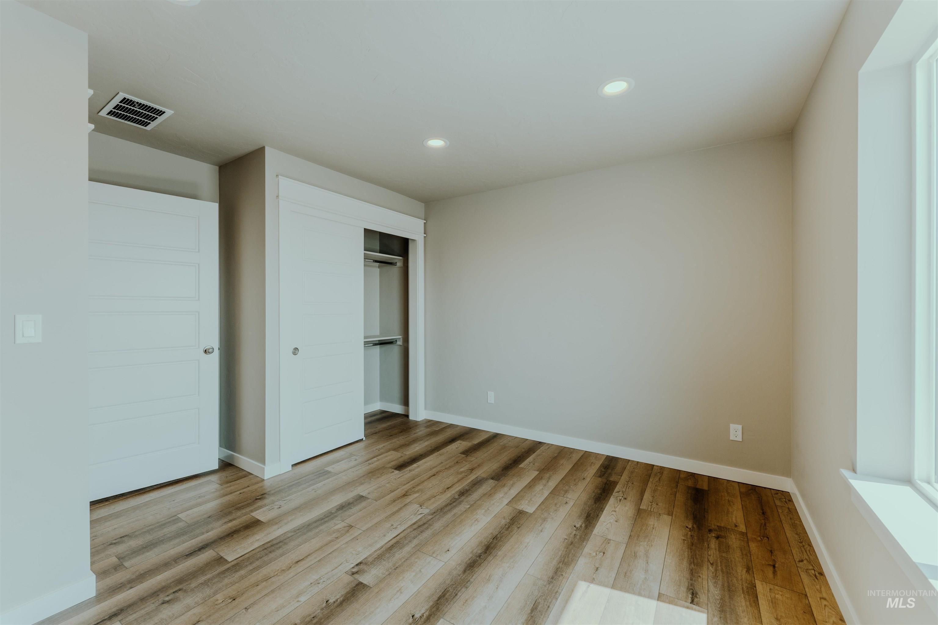 Unfurnished bedroom featuring recessed lighting, a closet, and light wood-type flooring