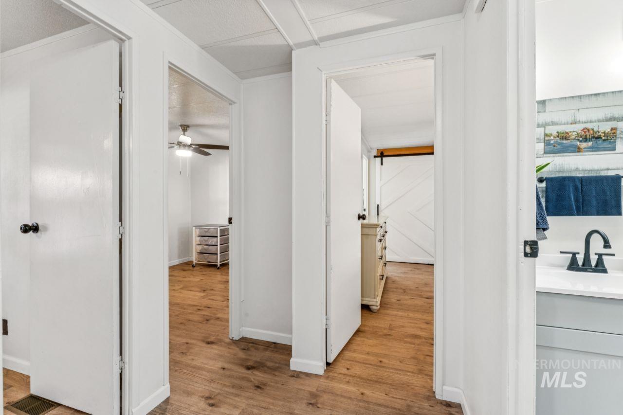 Hallway featuring light wood-style flooring and a sink