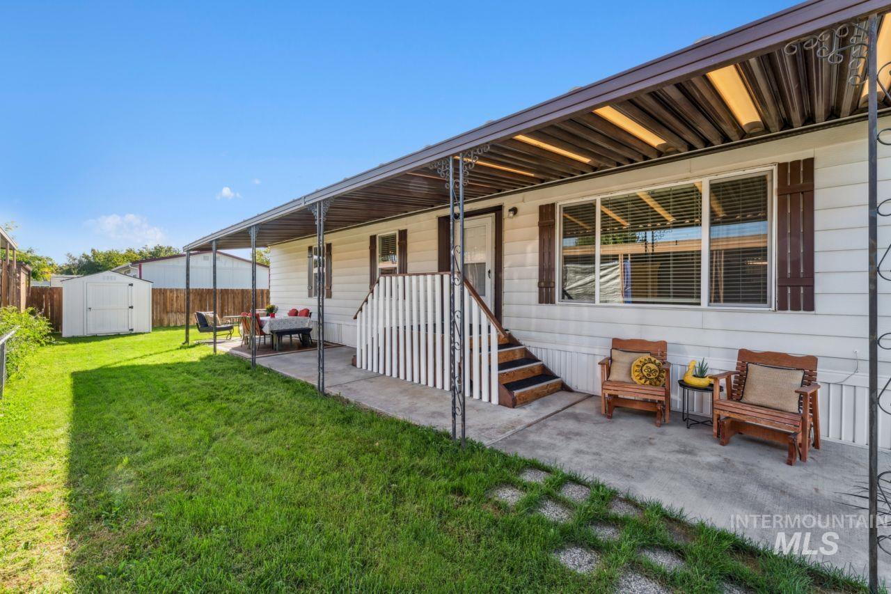 Rear view of house with a shed, a patio area, and covered porch