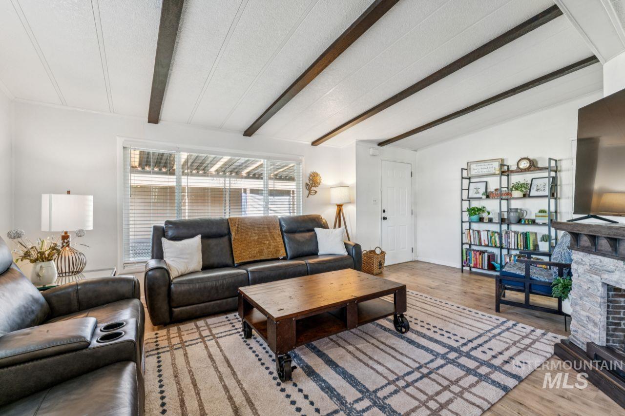 Living room featuring light wood-style floors and a fireplace