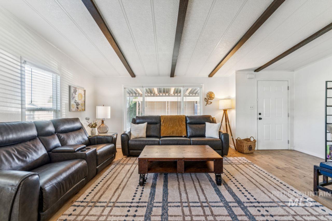 Living area featuring beamed ceiling and wood finished floors