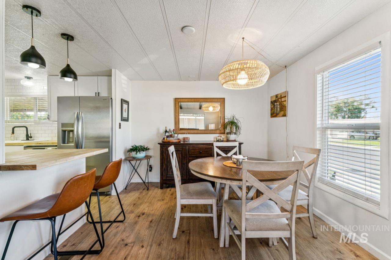 Dining space featuring light wood-type flooring and a textured ceiling