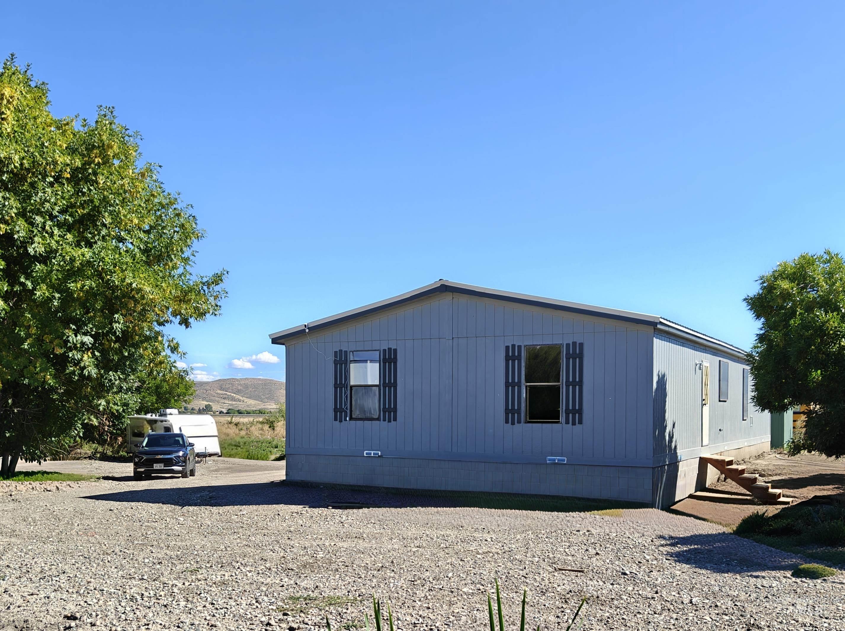 View of side of property with crawl space and a mountain view
