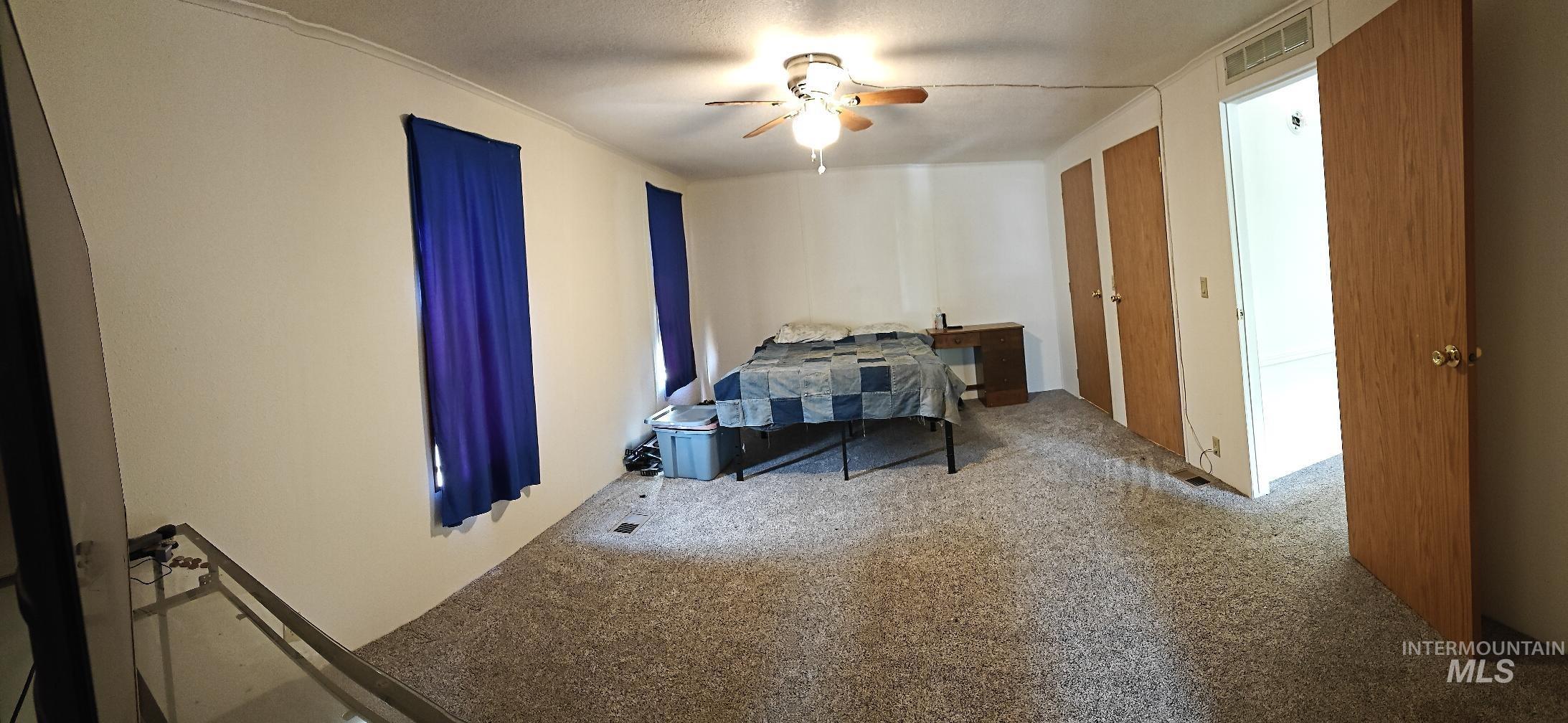Bedroom featuring carpet and a ceiling fan