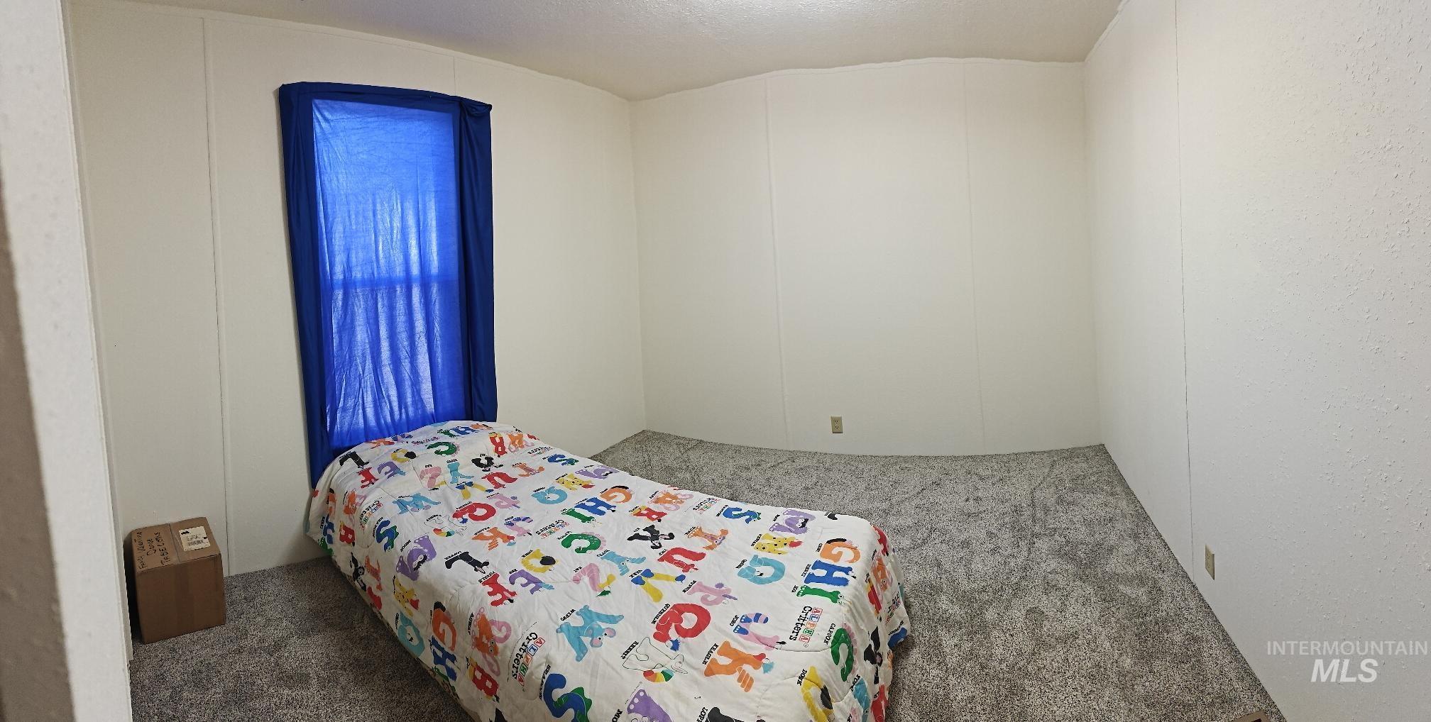 Bedroom featuring carpet flooring and a textured ceiling