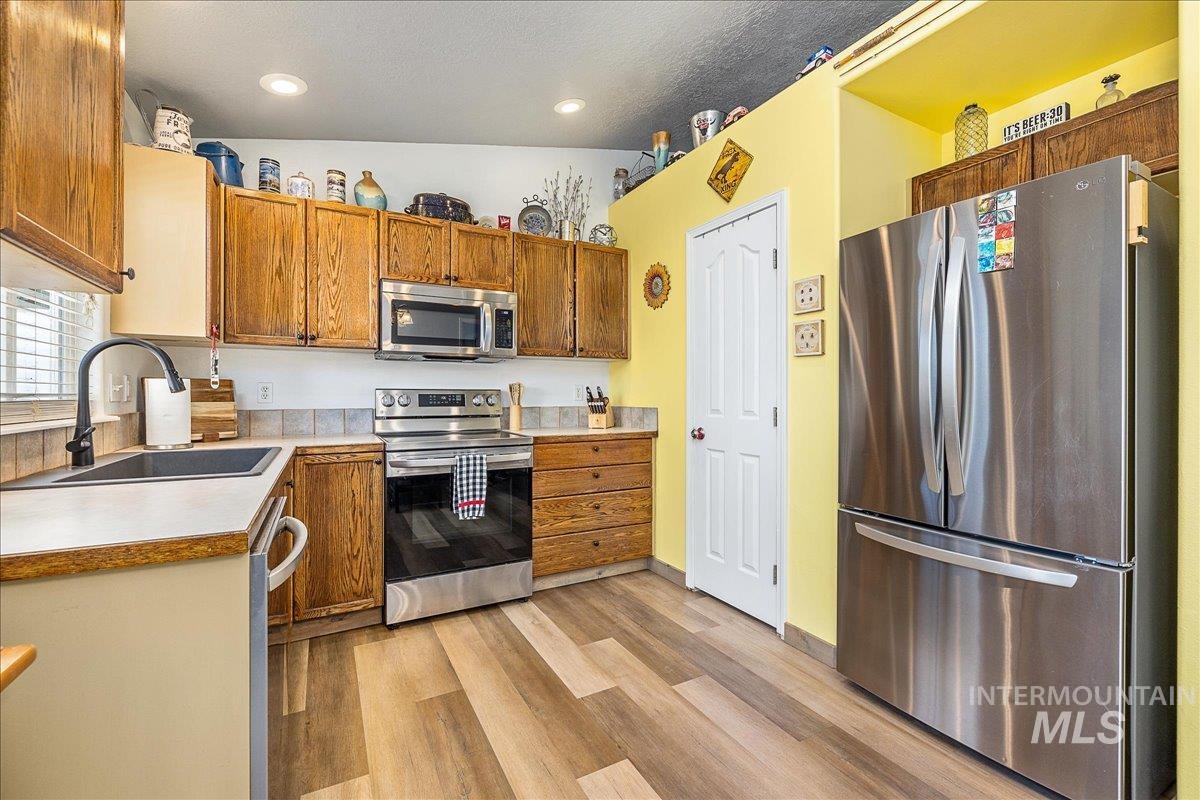 Natural and recessed lighting create a nice and light space for preparing meals.  Good amount of cabinets and don't miss the pantry! The large French style refrigerator is negotiable.