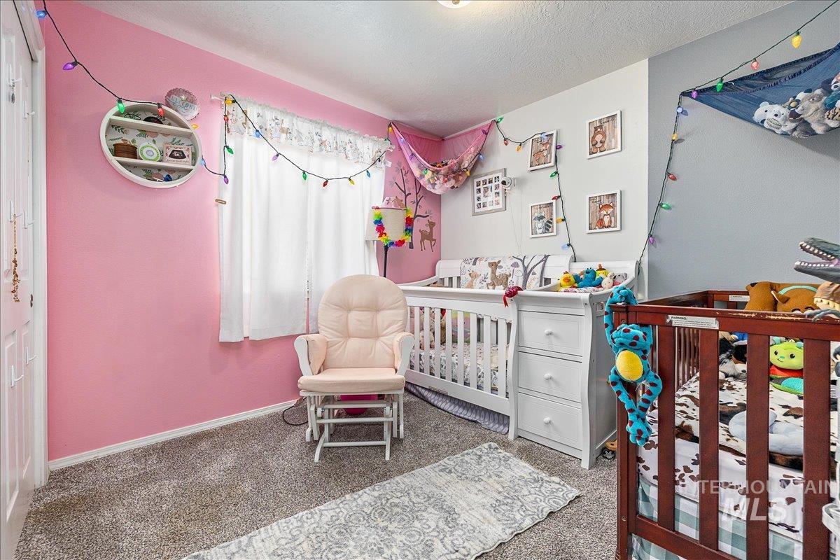 Good sized secondary bedroom is light and bright with cozy carpet underfoot.