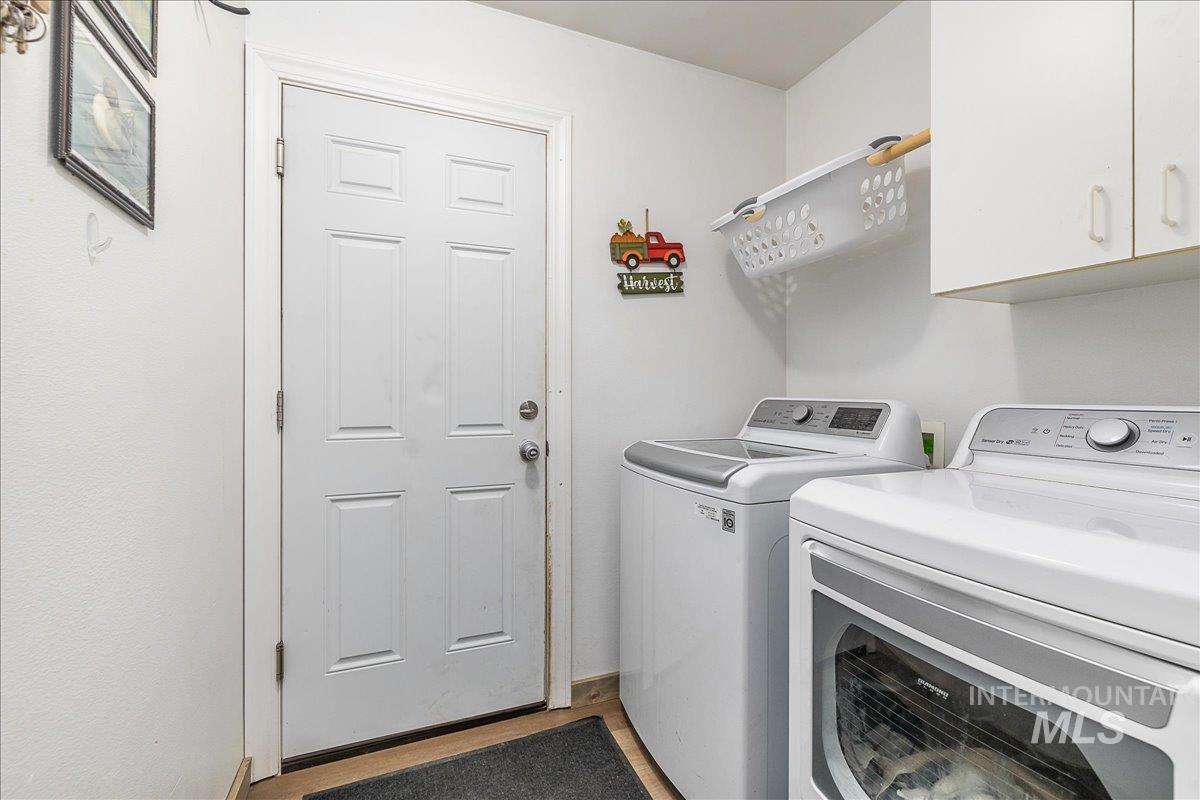 Interior laundry is a plus! This one is complete with a clothes hanging bar and cabinet!