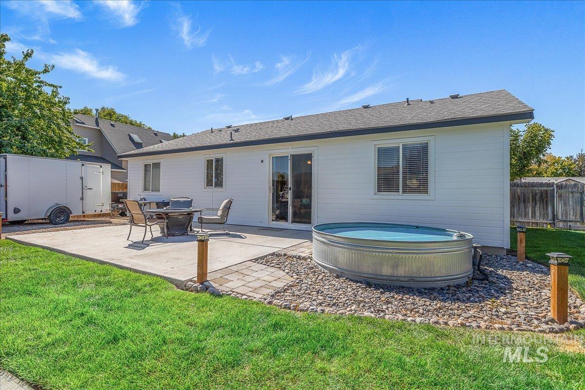 Back of house with a hot & cooling tub which remains, storage shed, and patio area. Let the outdoor fun begin!