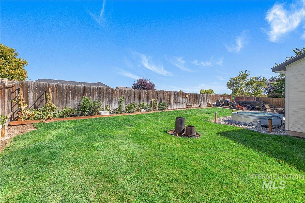 Fenced backyard with a hot & cooling tub.