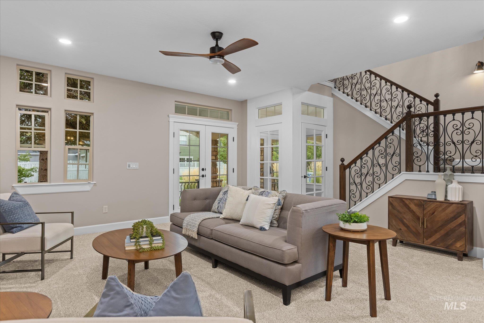 Living room with stairway, french doors, ceiling fan, and recessed lighting